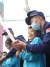 Children learn to use a water gun with the guidance from firefighters at the Beijing Fire and Rescue Force's compound on 19 November 2022.