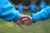 An adult and a child hold hands in a game during a celebration of the upcoming World Children's Day at the UN Compound in Beijing on 19 November 2022.