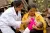 2011年，在云南省武定县猫街镇，一名妇女在医务人员的指导下进行母乳喂养。