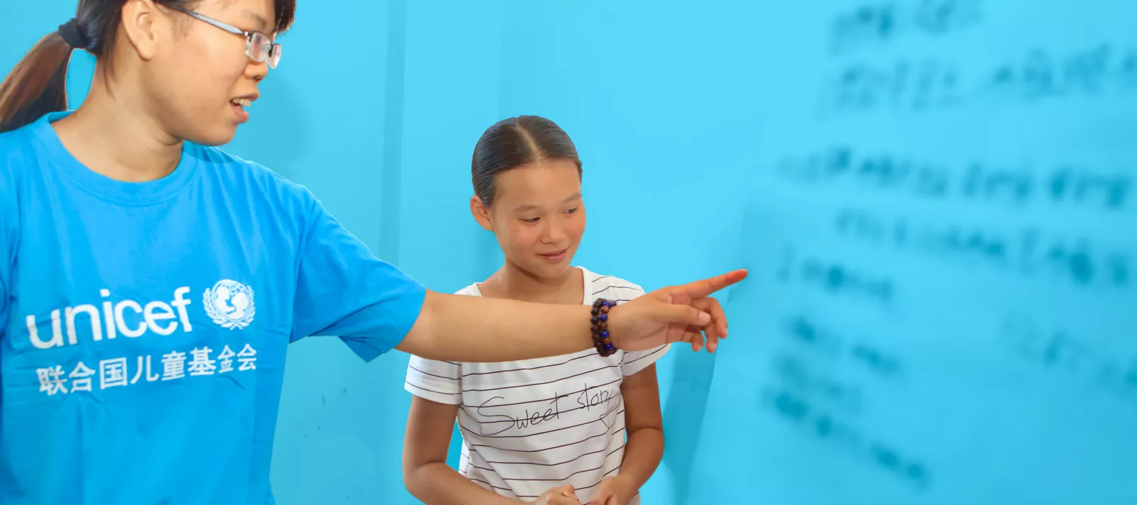 UNICEF volunteer teaching in school, China.