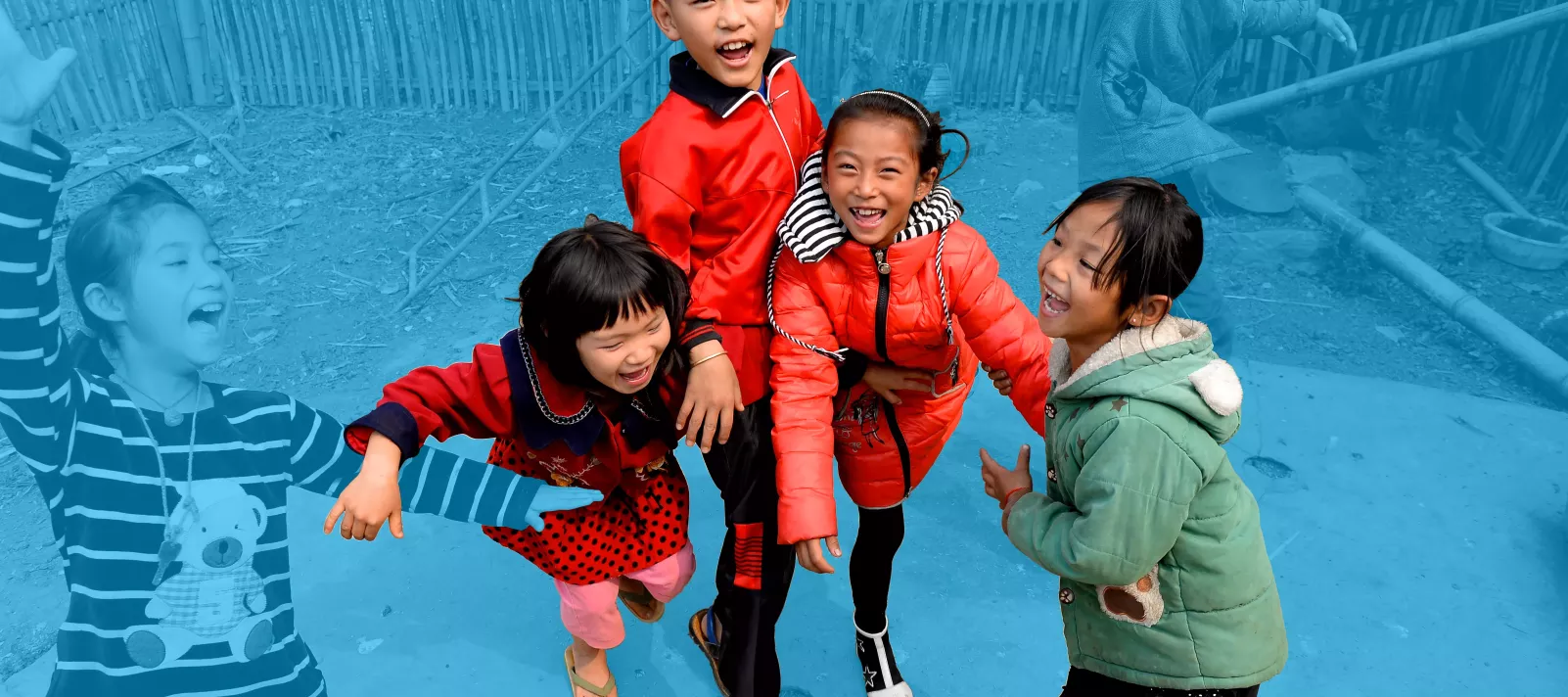 Girls and boys playing and laughing, rural China.