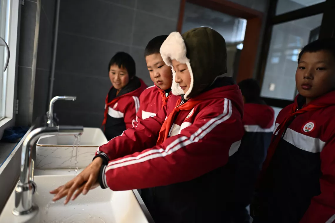 A primary school student washes his hands after using the toilet at a school in Golog Tibetan Autonomous Prefecture, northwest China's Qinghai Province, Nov. 2, 2023.