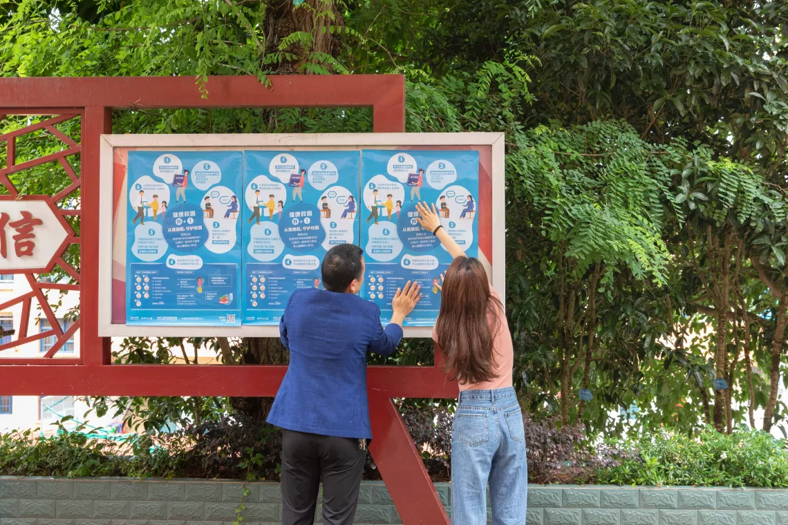 Teachers put up posters on tips for returning to school, produced by UNICEF, ChinaÕs Ministry of Education and the Chinese Center for Disease Control and Prevention, at Yixing School of Zhong County in Chongqing, China on 3 June 2020.