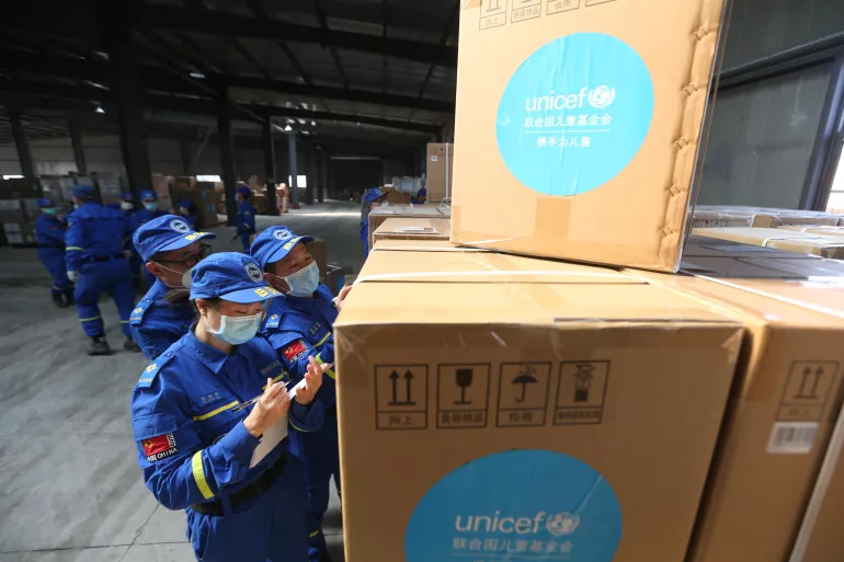 Volunteers check and accept UNICEF donated supplies in an emergency warehouse of the Hubei Charity Foundation in Wuhan, the epicenter of the COVID-19 outbreak, on 18 March 2020.