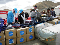 UNICEF field assessment team check and distribute newly-arrived winter jackets, trousers and socks to children in Chenduo County Complete Primary School on May 11, 2010.