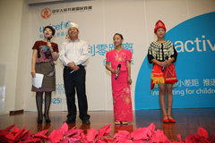 李正传（左二）自2012年开始担任云南省广帕村儿童福利主任。他和来自云南的两个小女孩，李兴欢（右一）和寸相柳一起向大家介绍儿童福利主任是如何在村里工作的。