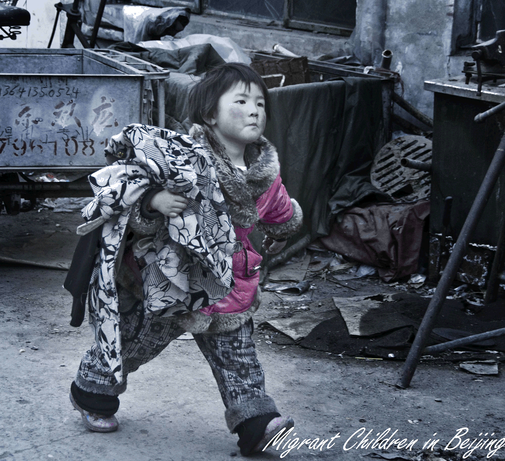 A 3-year-old girl helps her grandfather carry clothing to the garment workshop in which her parents work. 