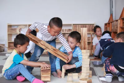 Photos show children building blocks at the Yelang Village Kindergarten.