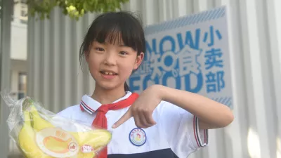 A student demonstrates what is healthy food outside UNICEF China’s ‘Know Your Food’ Convenience Store at the Enshi Experimental Primary School in Enshi, Hubei Province, on 20 May 2022.