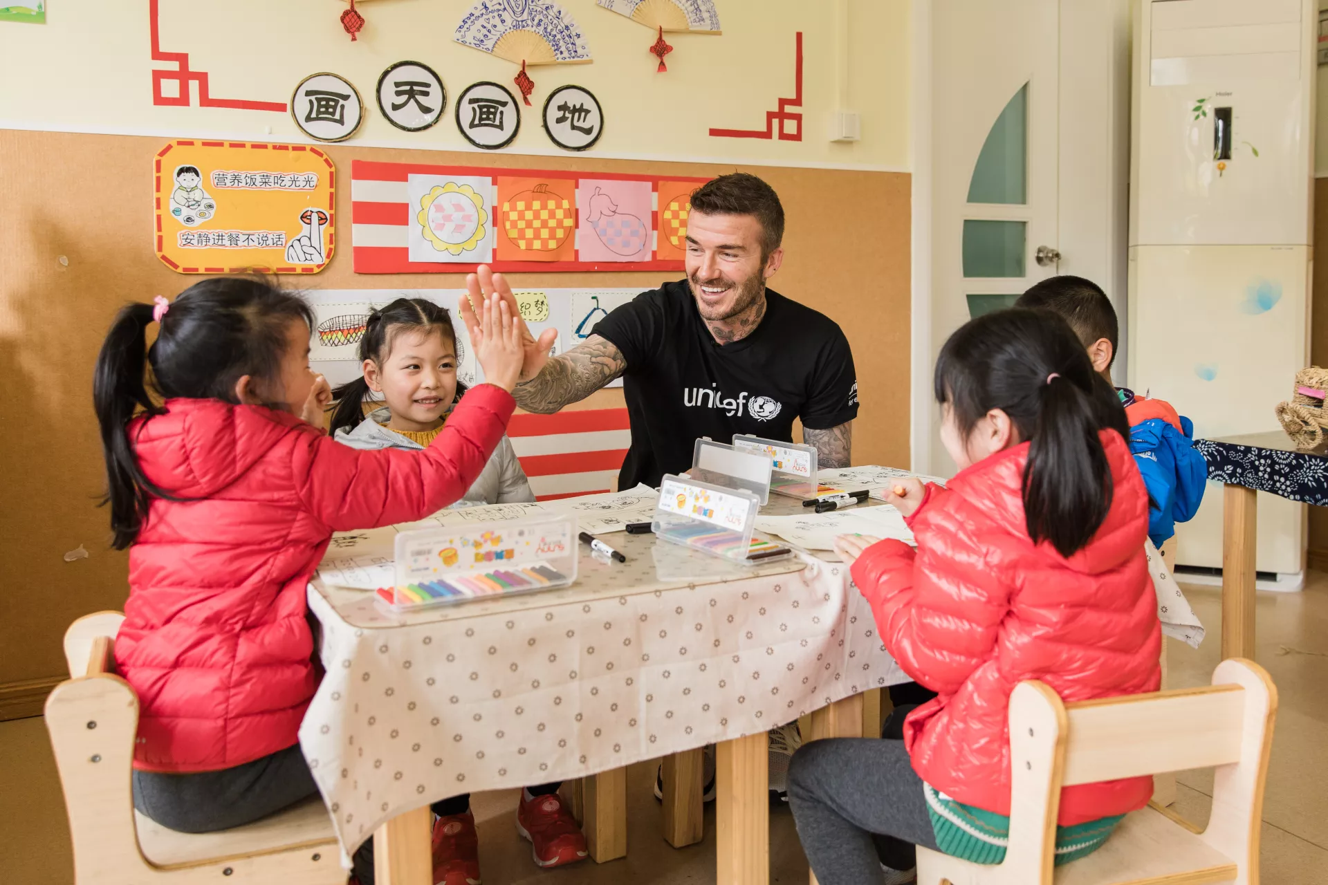 UNICEF Goodwill Ambassador and Global Icon David Beckham high fives with a girl during a visit to Xianghuaqiao Kindergarten on the outskirts of Shanghai, China, on 27th March 2019.