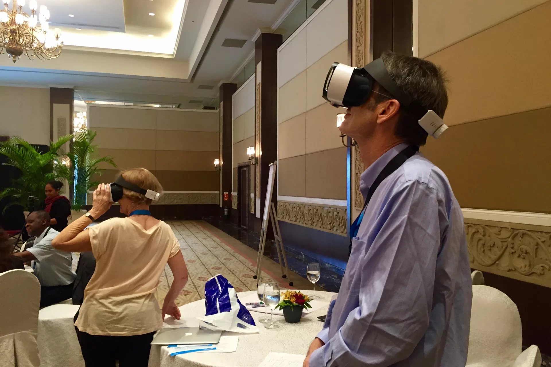 At the parenting support intervention workshop, participants try UNICEF China's virtual reality devices which show the barefoot social worker and ECD center pilots (L-R: Glen Palmer, International ECD Expert and Stephen Blight, UNICEF Regional Child Protection Advisor)