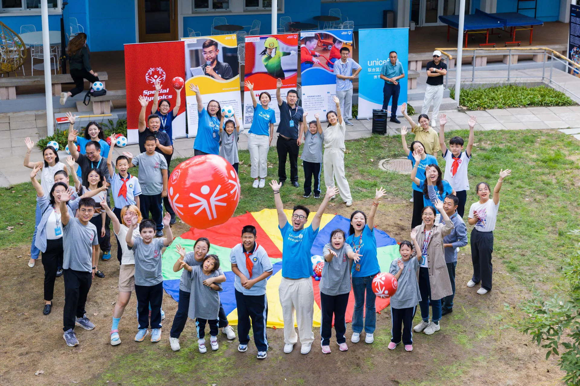 Participants cheer together in UNICEF China's green space after the event.