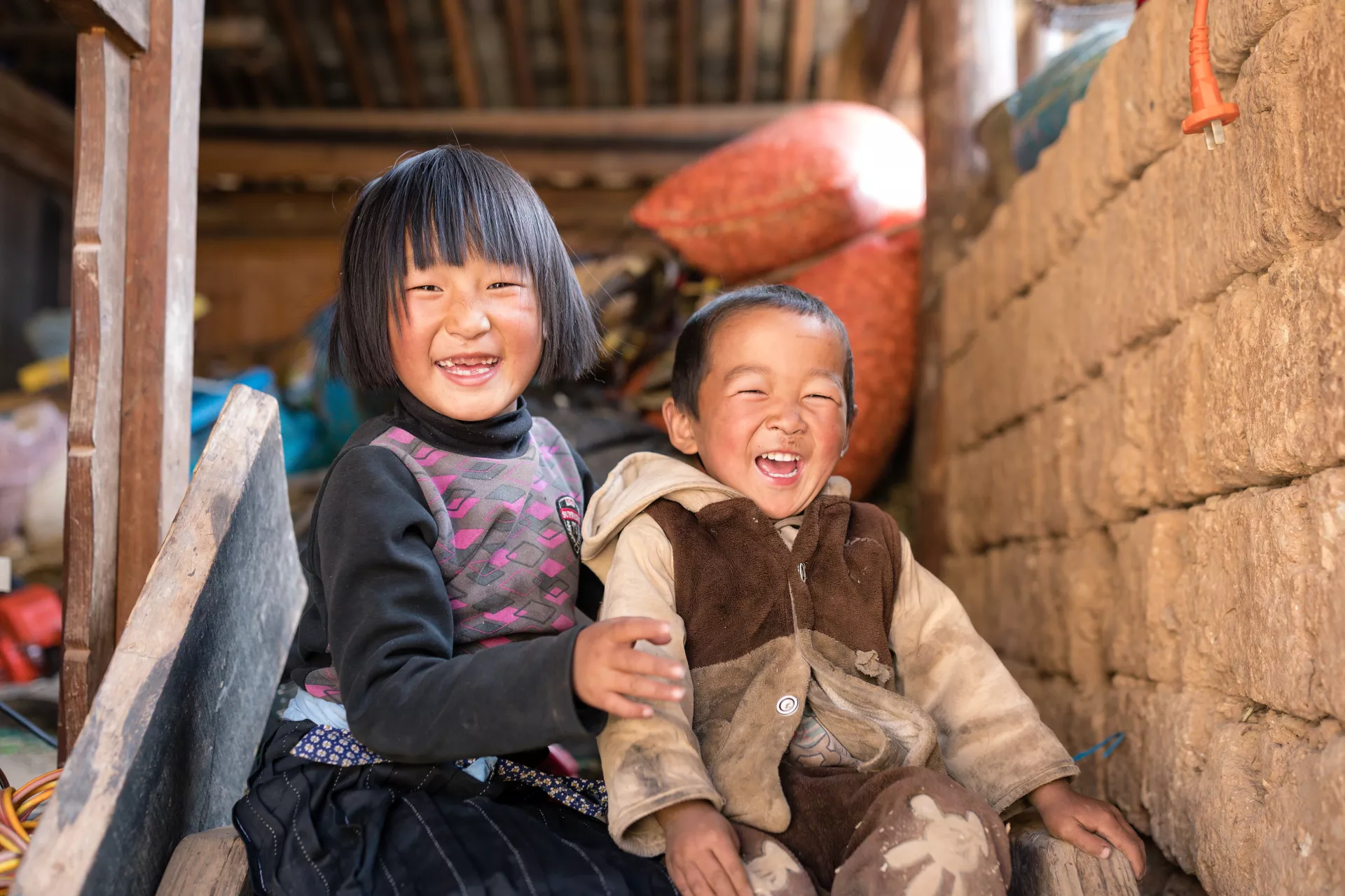 Girl and boy laughing, China
