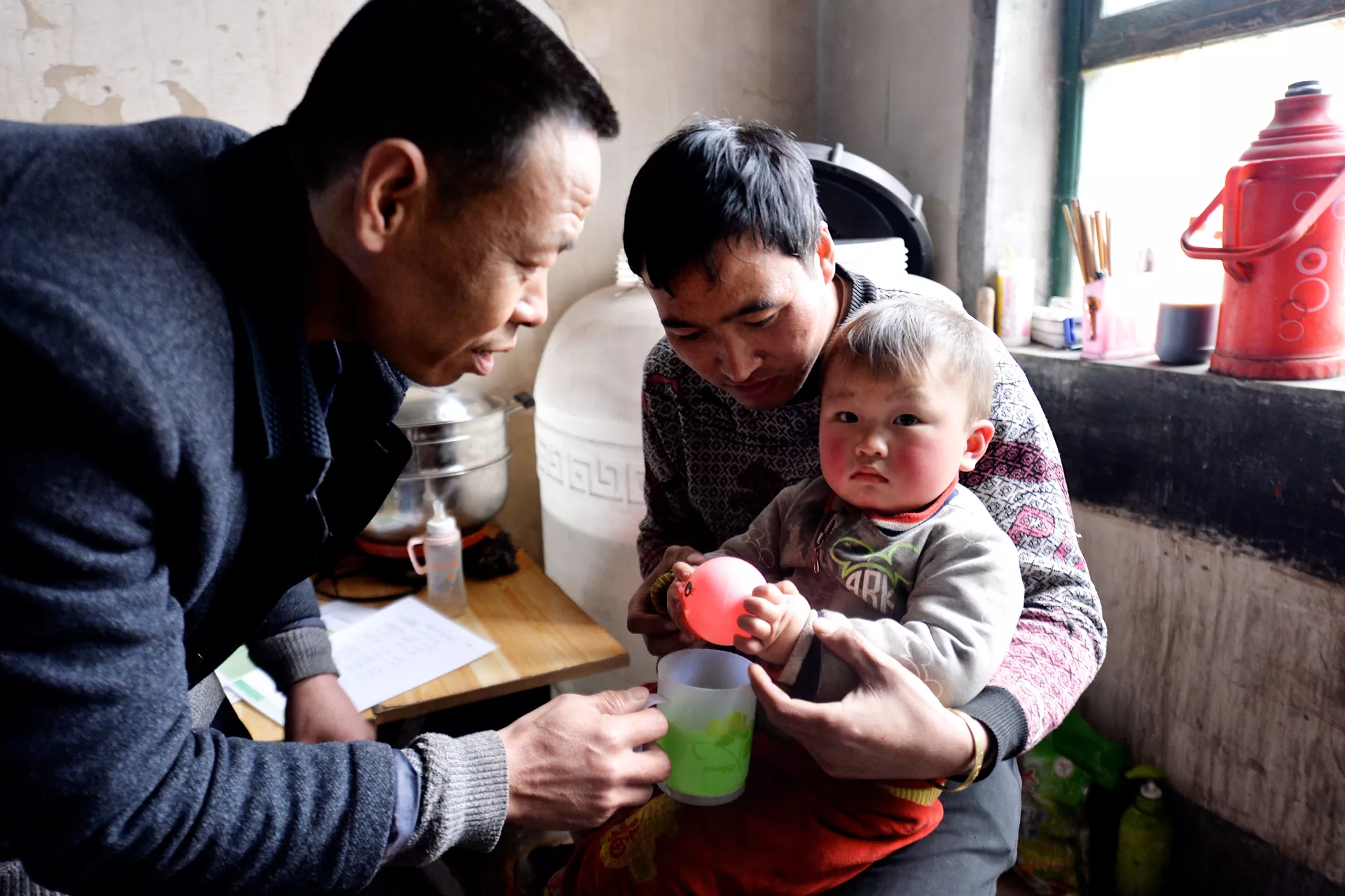 A village doctor pays a home visit to a child in Fenxi County, Shanxi Province, in 2017. 