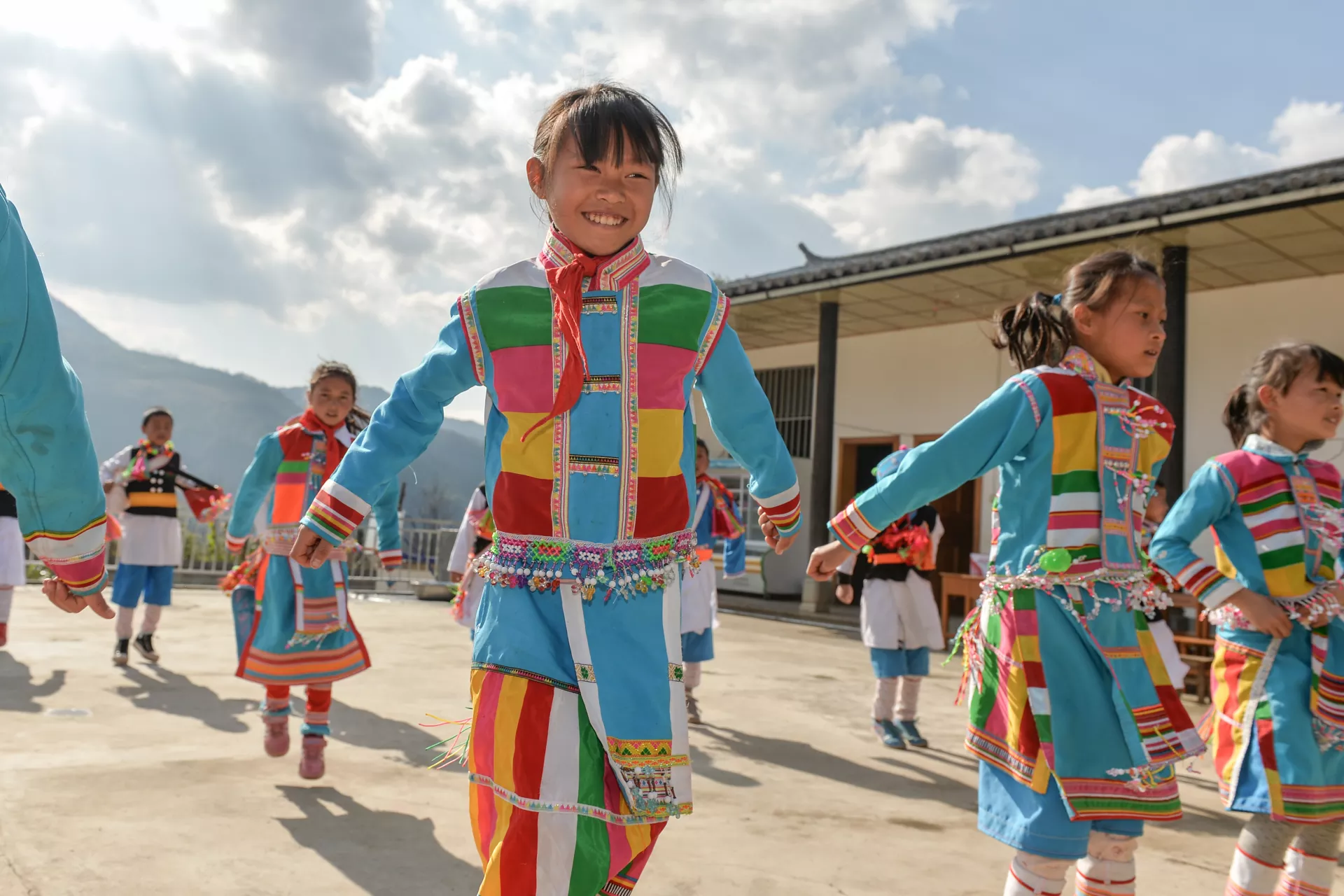 Students dressed in the traditional clothing of the Lisu ethnic minority dance during a UNICEF field visit on March 9, 2016 at Shaohuiba Primary School.