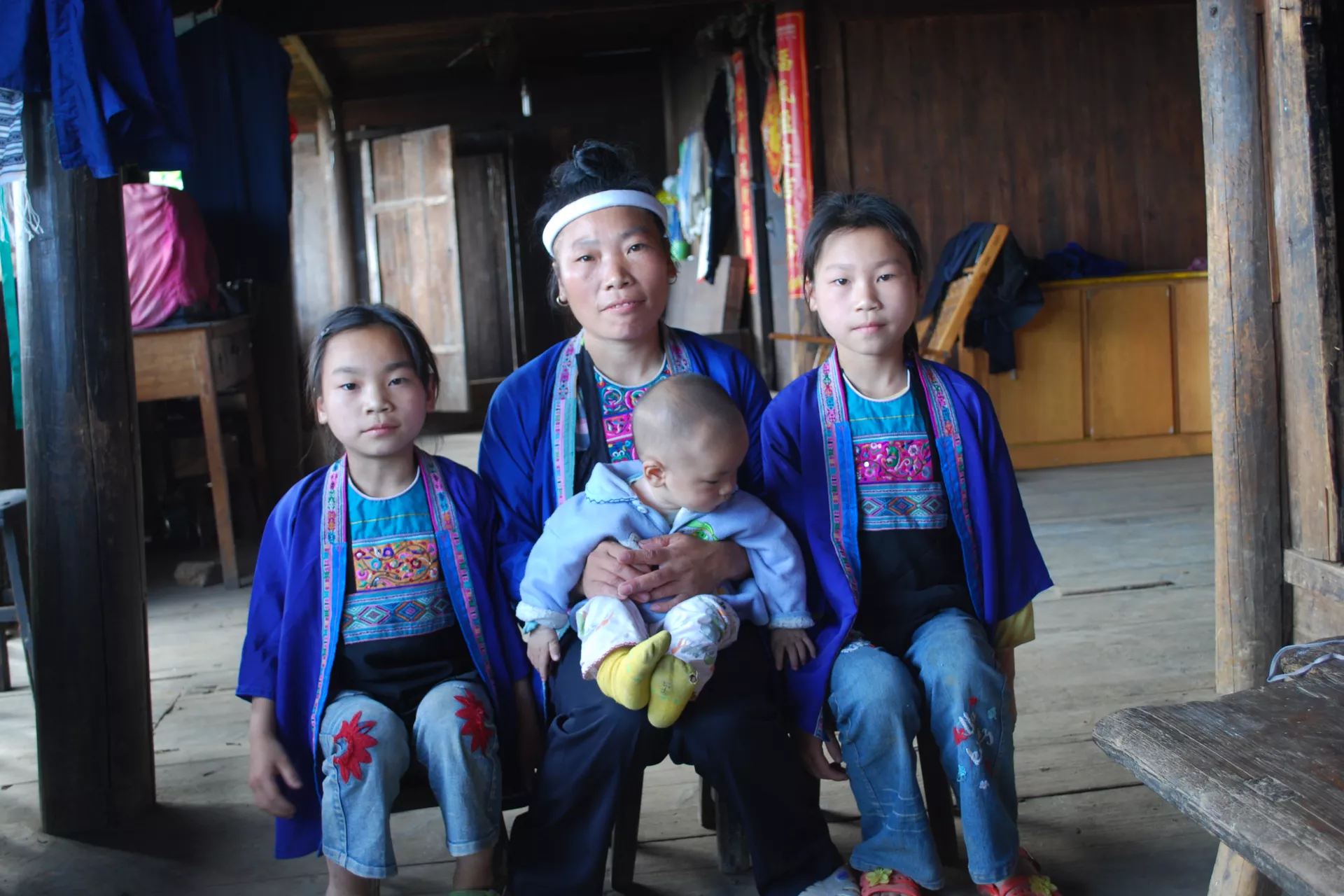 Ni Peijiang and her children pose for a family picture at their home.