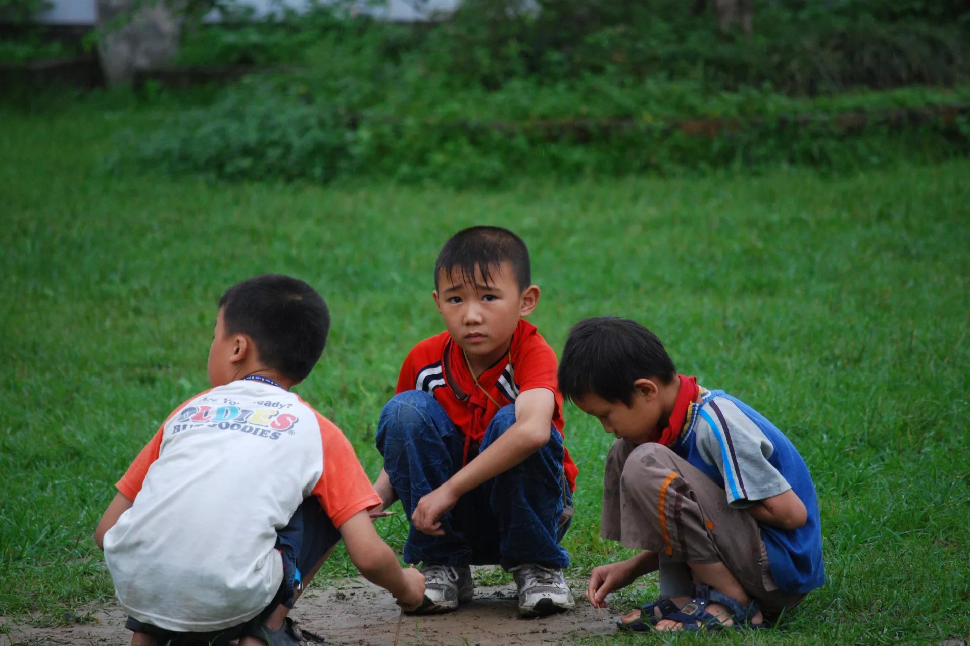 Huang Huijie(middle) plays with his friends at the playground during a recess.