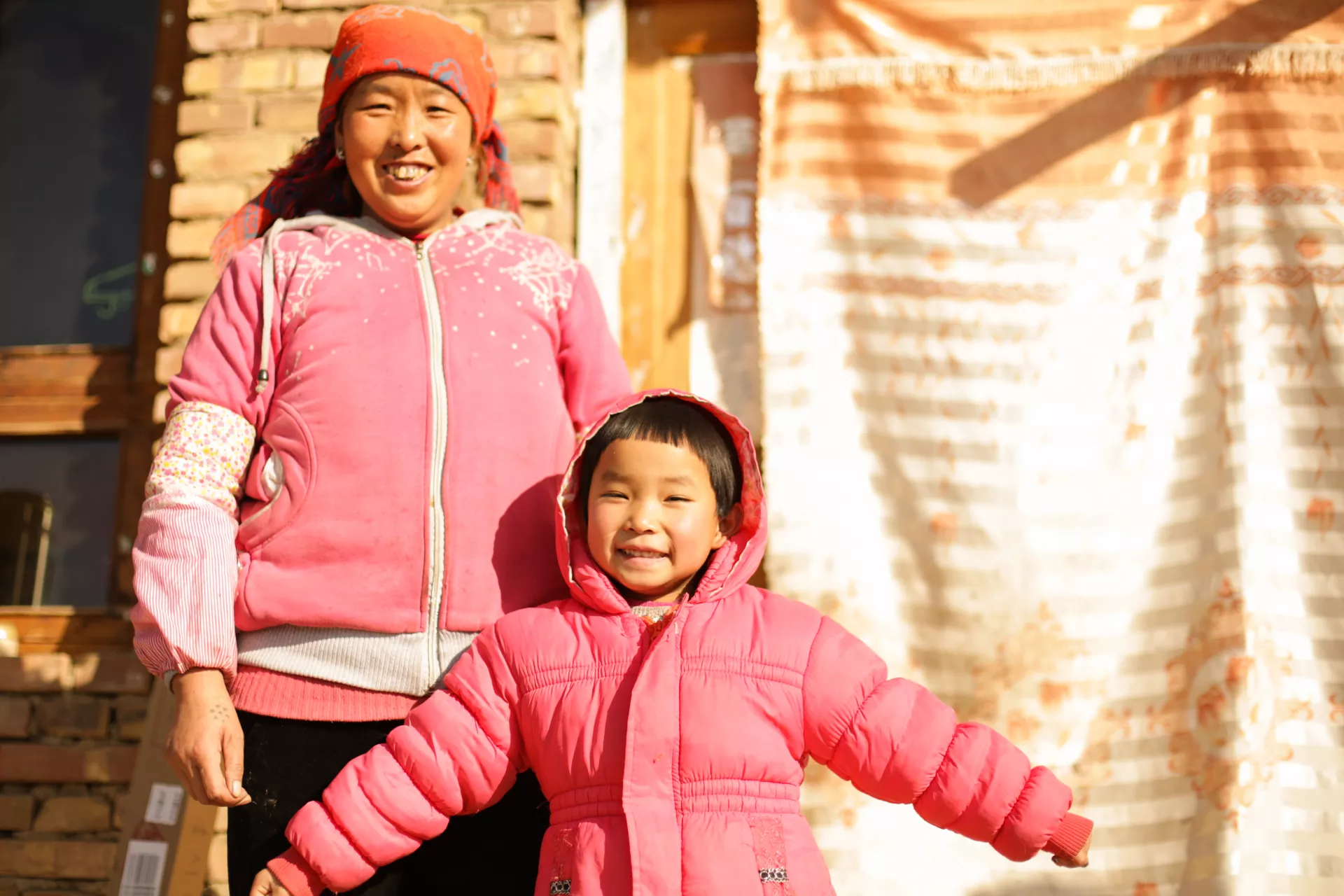 A girl and her caregiver at their home in Dingxi County, Gansu Province, in 2017.