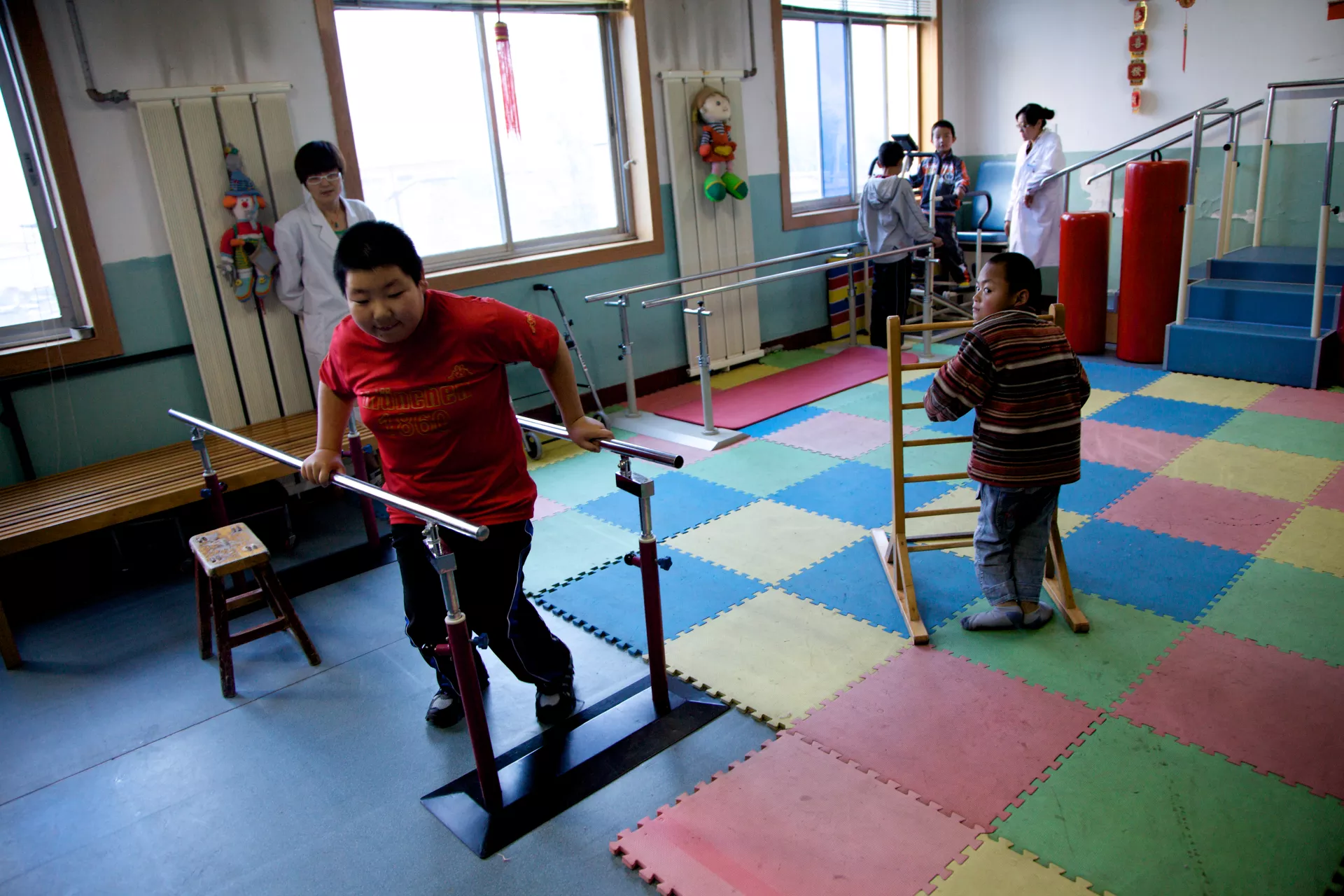 Children with disabilities receive rehabilitation service provided by professionals in Lanzhou Child Welfare Institute.