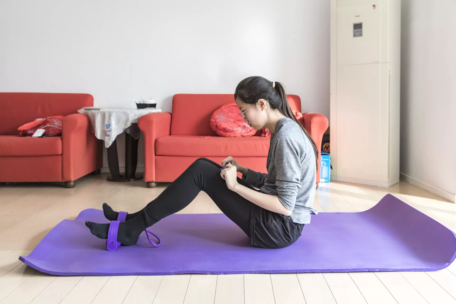 A girl from Beijing does exercise at her home on 18 February 2020. 