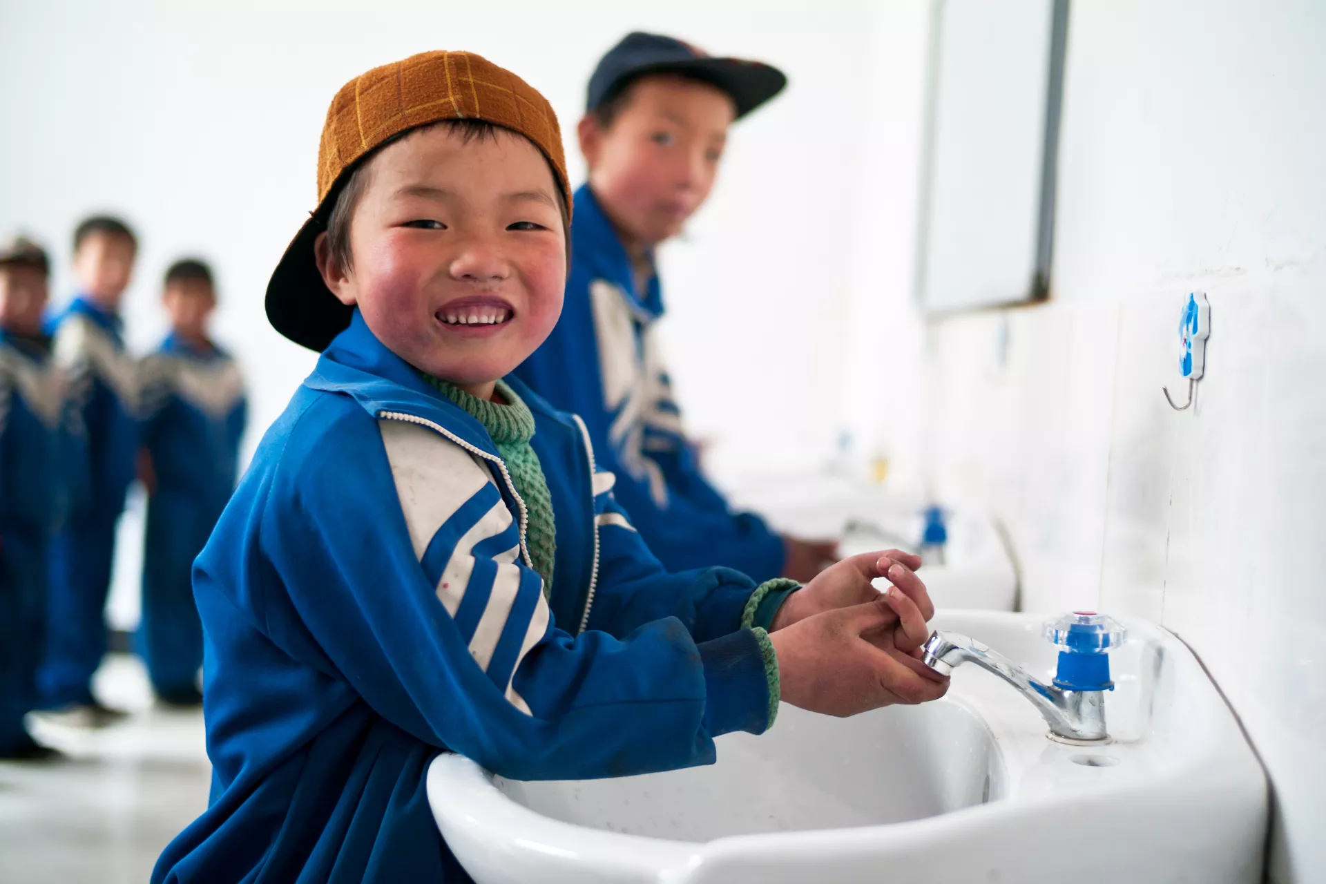 Children use clean water facilities and sanitary latrines in Xihe County.