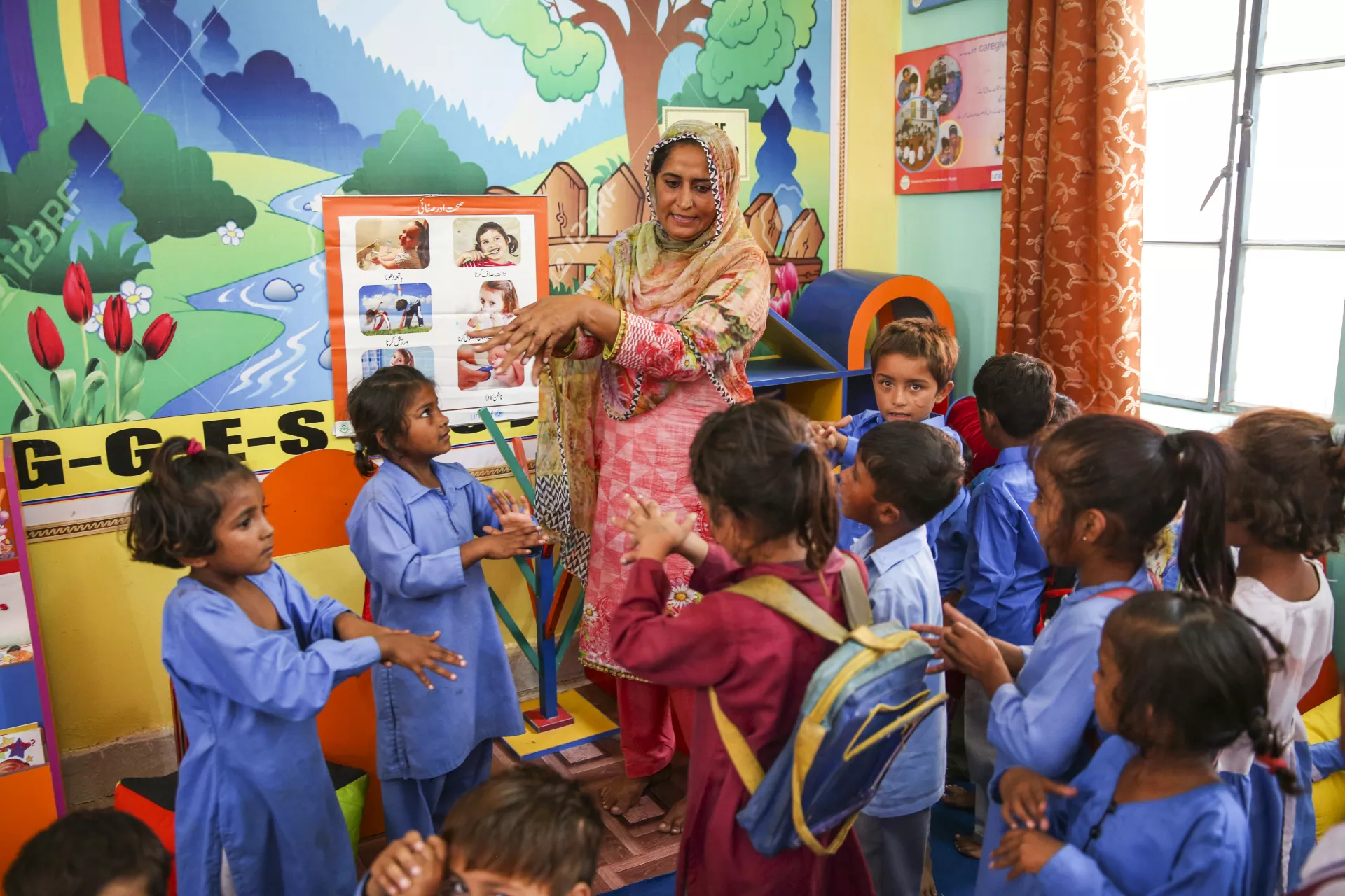 Khalida Kamil, assistant teacher teaching hand washing steps to the students of Early Childhood (ECE) class in government girls elementary school Khato Kalan in Toba take sing district, Punjab province, Pakistan.