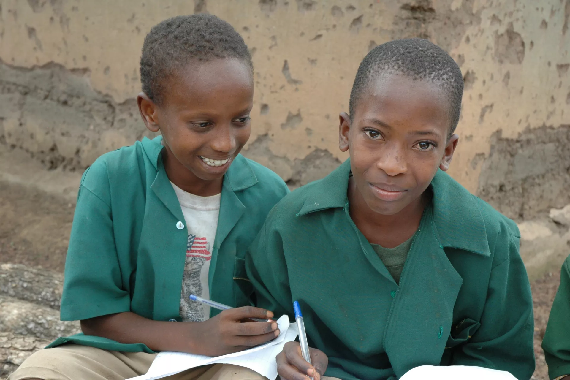 In May 2007, two schoolchildren in Sierra Leone’s Koinadugu district are doing their homework together. 