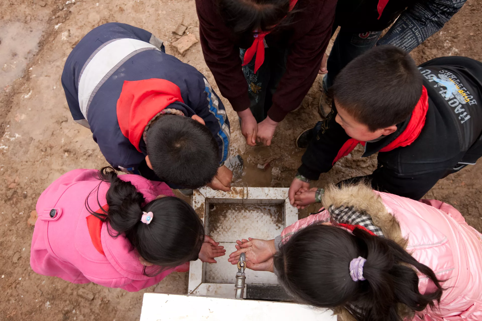 Boys and girls wash their hands during recess at Caochuan Primary School, Xihe County, Gansu Province, China.