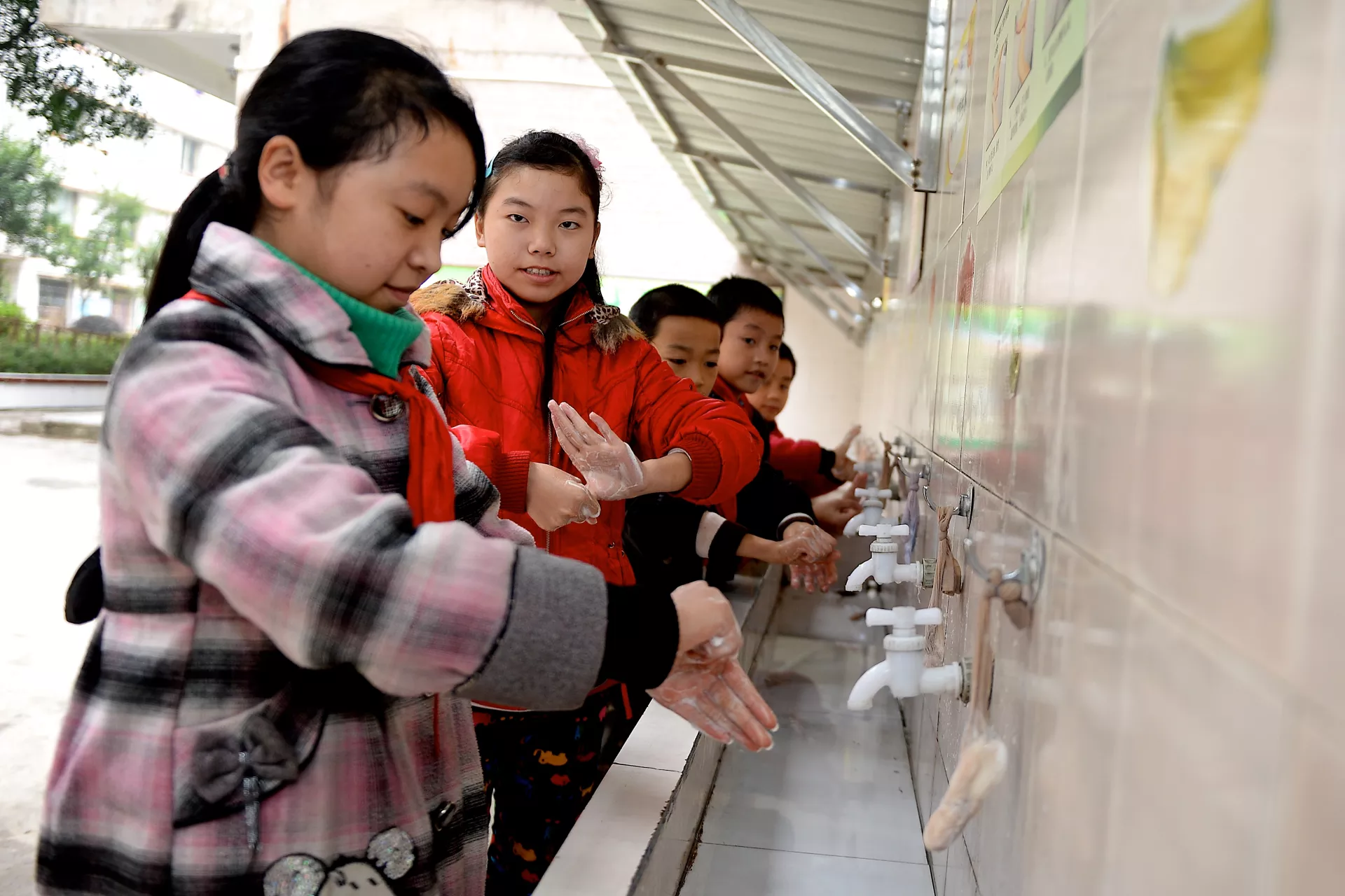 Children wash their hands at a primary school in Zhong County, Chongqing, in 2015.