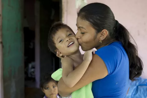 Delfina Sanchez kisses her 2-year-old son, Ecni ‘Jesus’ Gonzalez Sanchez, who has cerebral palsy, at home in La Chorrera District in Panama Province.