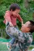 2023年4月，在江西省遂川县仙溪村，一名父亲在儿童之家组织的活动中把孩子高高举起。