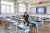 2020年6月3日，重庆忠县任家镇义兴学校内，一名教师在为教室课桌椅消毒。