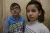 On 21 December 2013 in the Syrian Arab Republic, (left-right) Ammar, 11, and his sister Raama, 8, stand in their two-room shelter in a former private hospital, where internally displaced people are currently staying. 