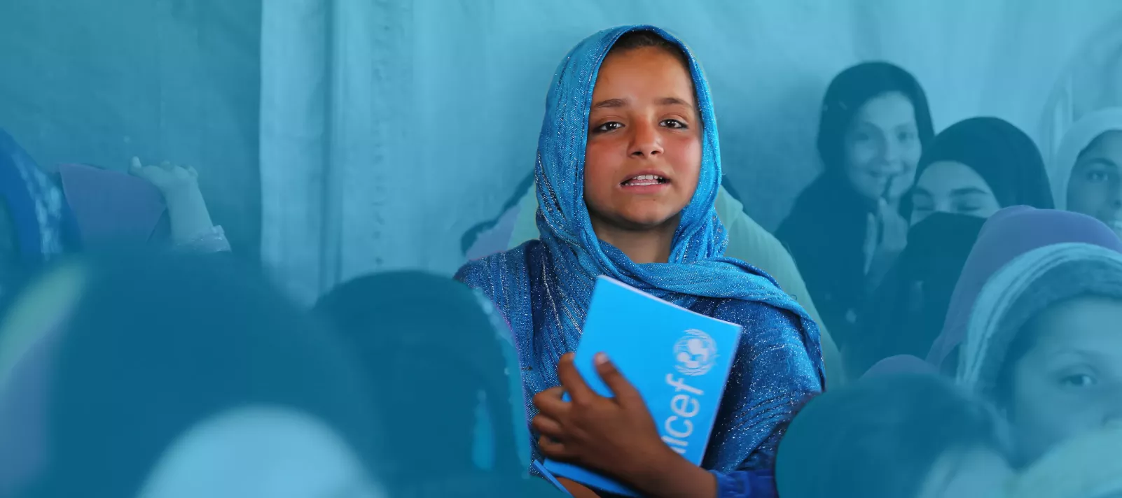 A 10-year-old girl sits in a tented class at a community-based school in Laghman, Afghanistan, in 2017.