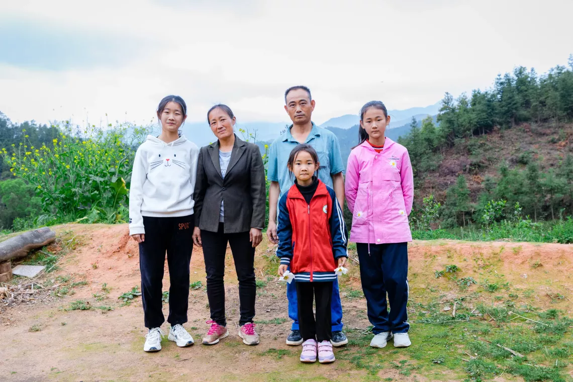 A family from Suichuan County, Jiangxi Province, pose for a picture in March 2023.