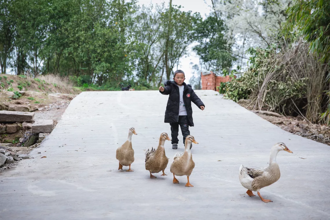Xiaohua’s companions at home are the family dog and several ducks, which he helps to feed.