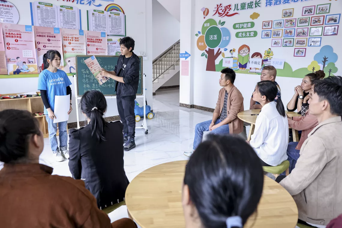 During a positive parenting session at the Children’s Place in Dalu Village, Lingshan County of Guangxi Zhuang Autonomous Region, using parenting tips developed from a UNICEF campaign, UNICEF Ambassador and renowned actor Chen Kun demonstrates to a group of caregivers how to handle different scenarios in parenting based on the core concepts of ‘empathy, communication, respect, role modelling and trust’ on 13 May 2023.