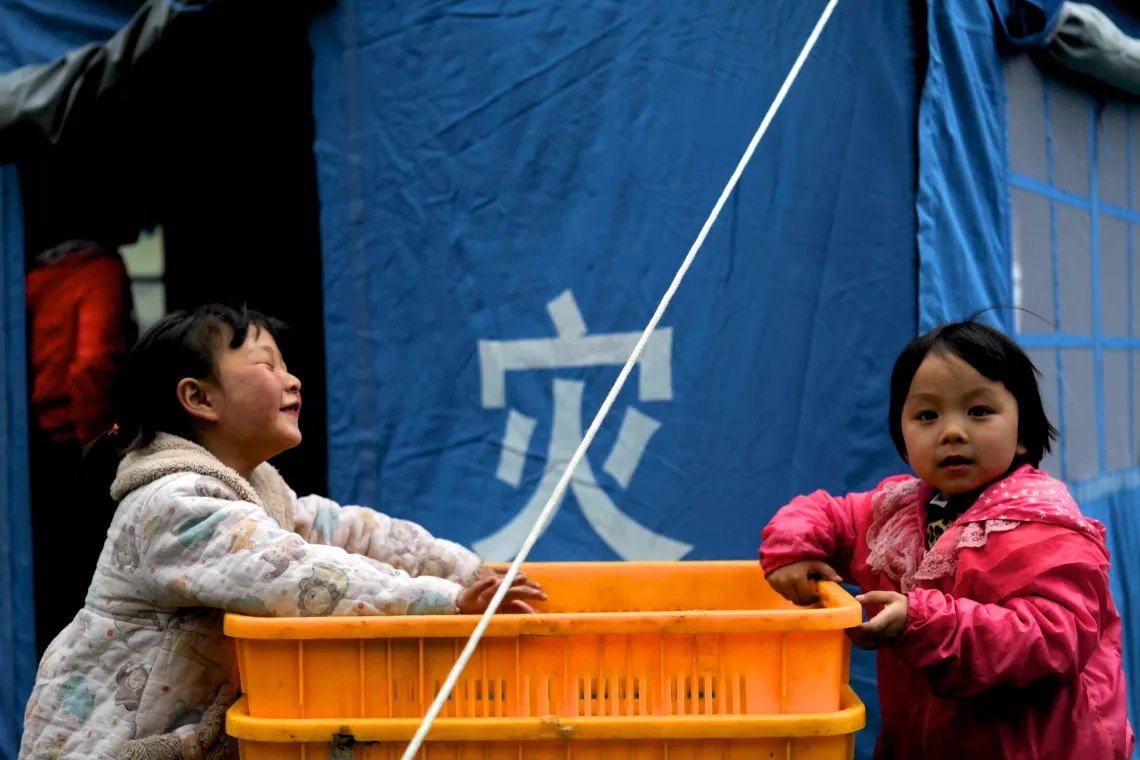April 21, 2013, two children playing in a temporary settlement area of Baoxing County.
