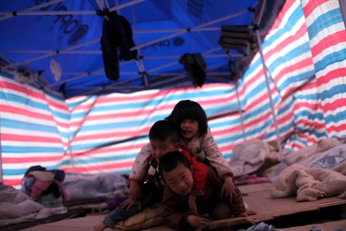 April 22, 2013, children playing in a tent in a temporary settlement area in Baoxing County.