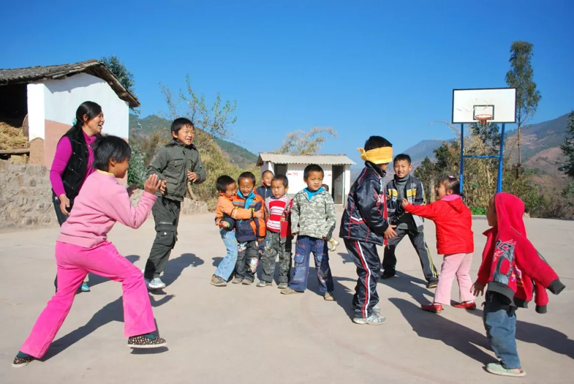 Xiong and her students in the school's playground.