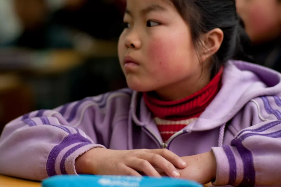 Wang Yanling, 12, studies in a new prefabricated classroom with schools supplies provided by IKEA Social Initiative.