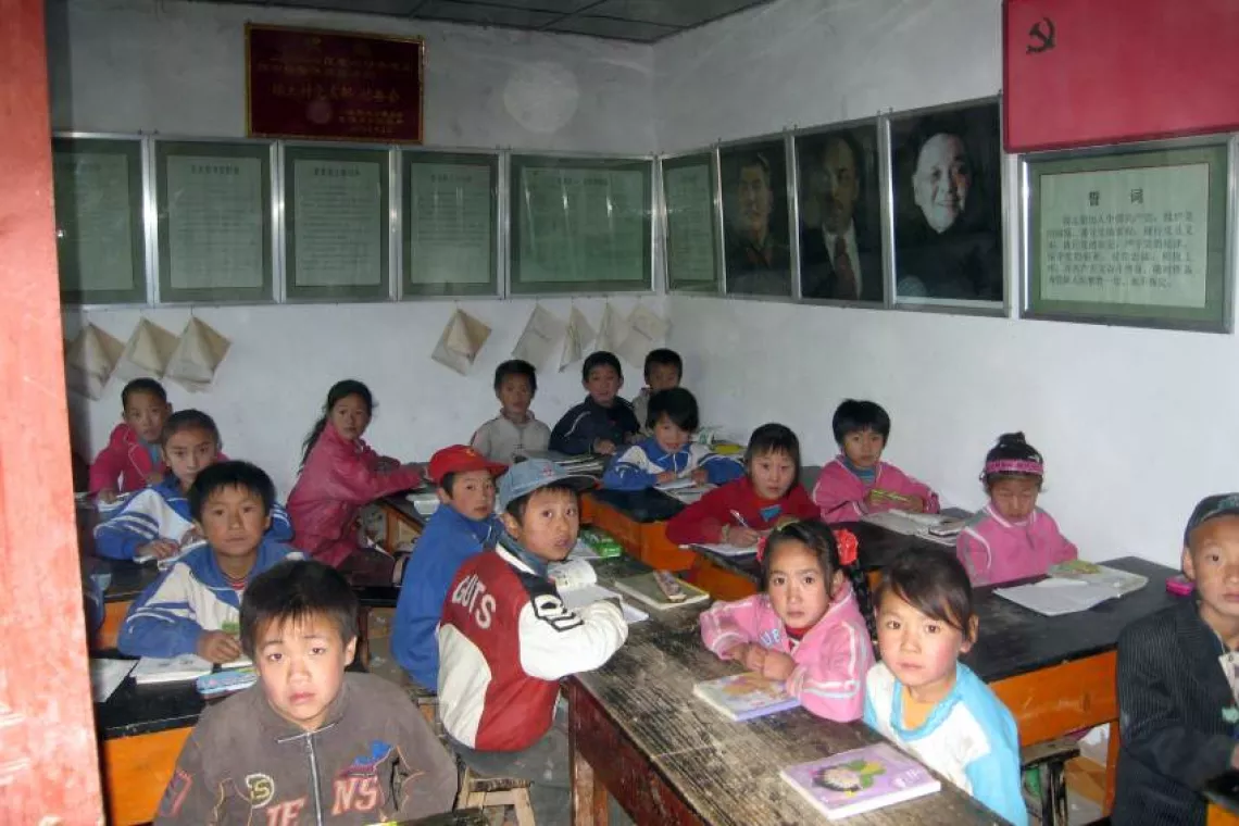 In several schools damaged by the quake in Xihe County, children had to squeeze into village activity rooms such as this to resume study.