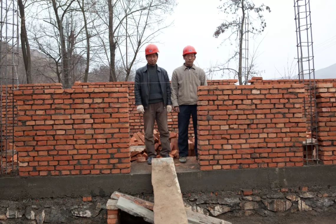 A year after the earthquake, a new handwashing facility connected to a safe water supply is under construction near the prefabricated classrooms in Caoyang Primary School.