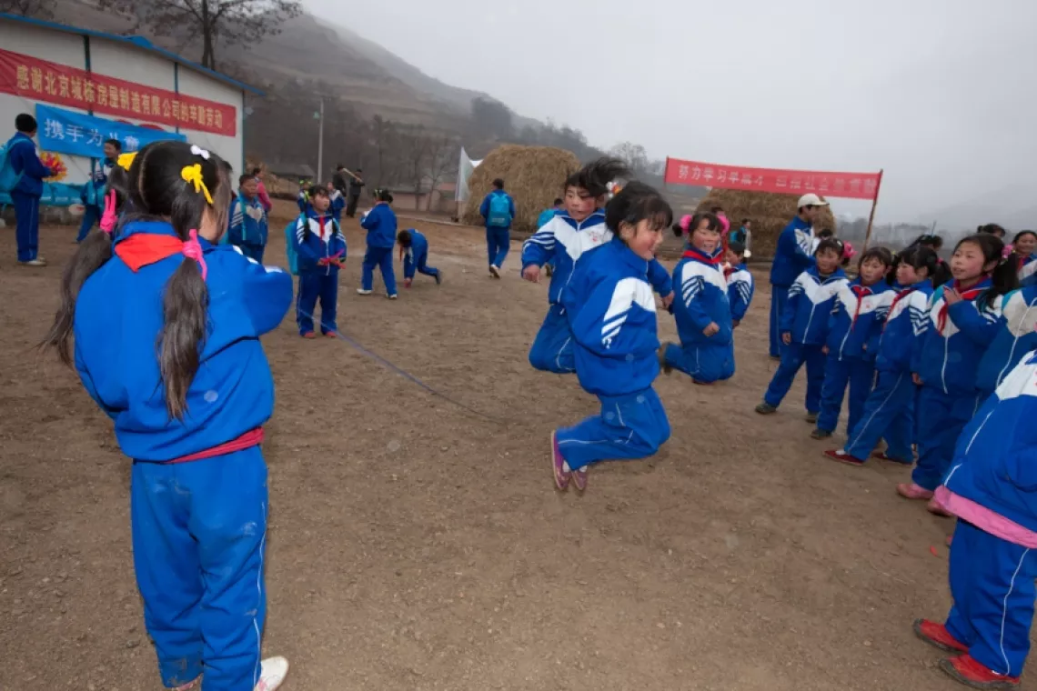 Children play sports at the playground in Caoyang Primary School.
