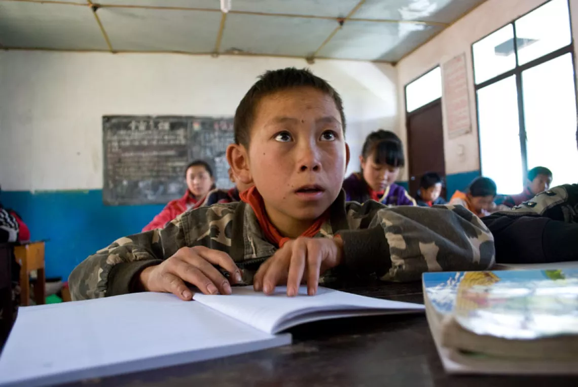 A boy takes notes during a Chinese class.