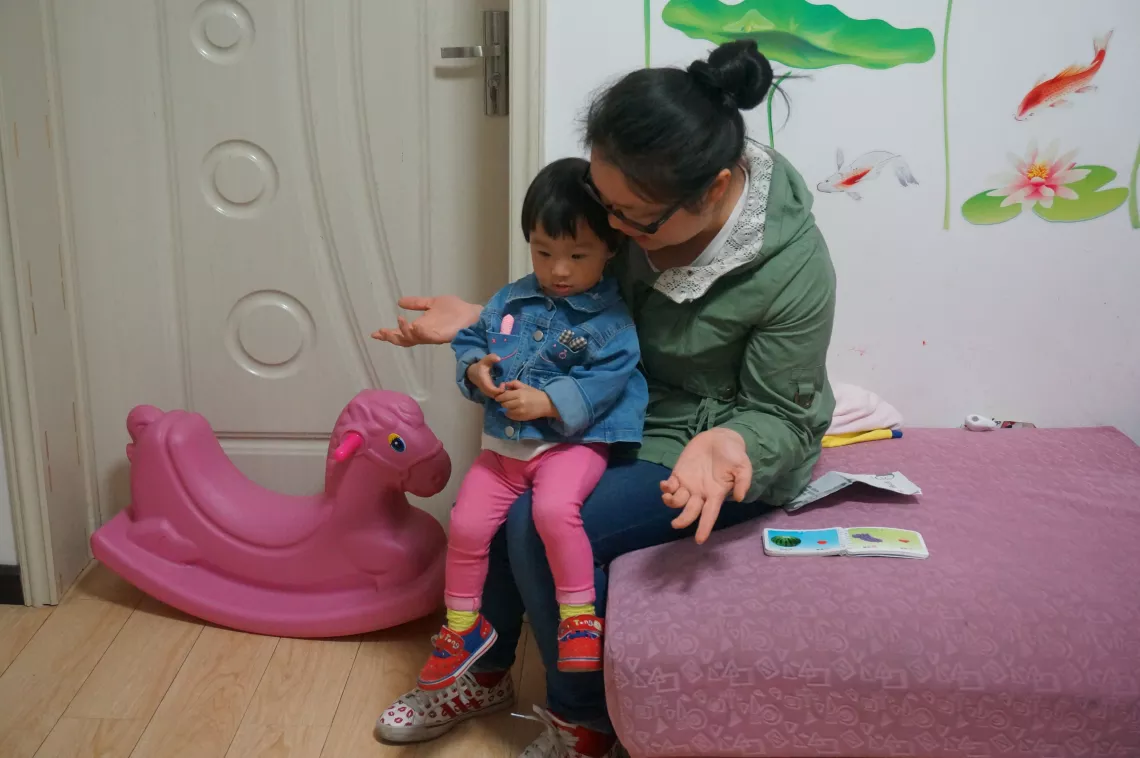 Yang Yuman and her 18-month-old daughter Yaya daily visit the community ECD centre because it provides a safe and colourful environment to play.