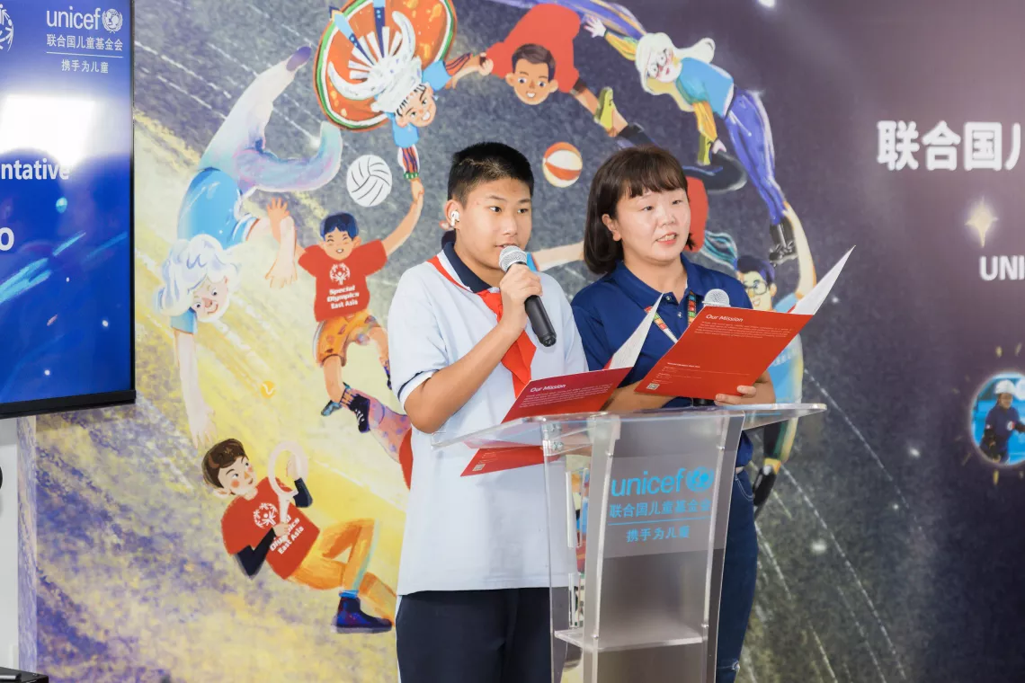 Special Olympics athletes representatives, Jia Sirui (right) and Song Yanshuo give a speech at the event.