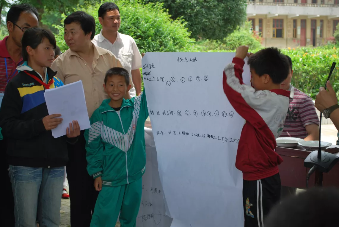 Children present their opinions after a group discussion.