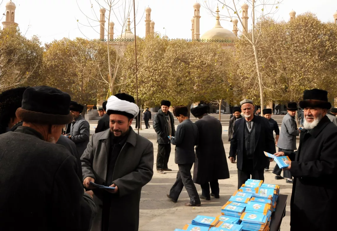 Uyghur language brochures on polio are distributed at Friday prayers outside the Grand Mosque of Moyu. 