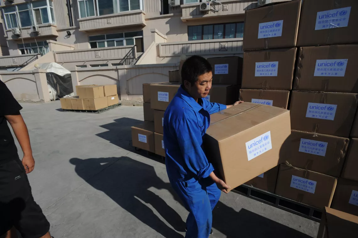 On 18 September 2012 a worker is loading a box of UNICEF emergency supplies bound for Yiliang County in Yunnan Province.